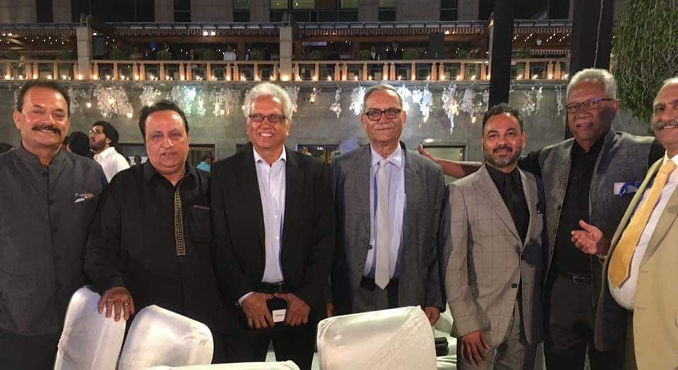 Group of well-dressed attendees including Haute Services founder Maneesh Baheti with celebrities and notable personalities at an upscale evening event