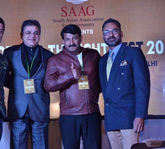 Group of prominent individuals including Haute Services founder Maneesh Baheti with celebrities at an elegant event